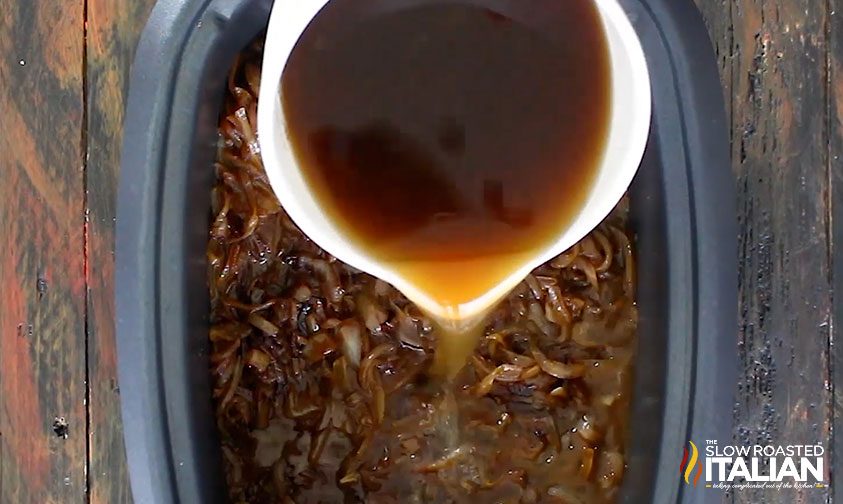 pouring beef stock into the slow cooker