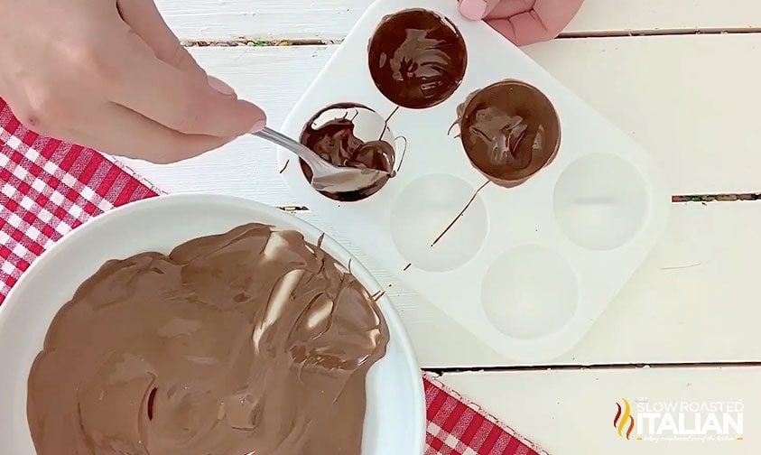 spreading melting chocolate in the mold