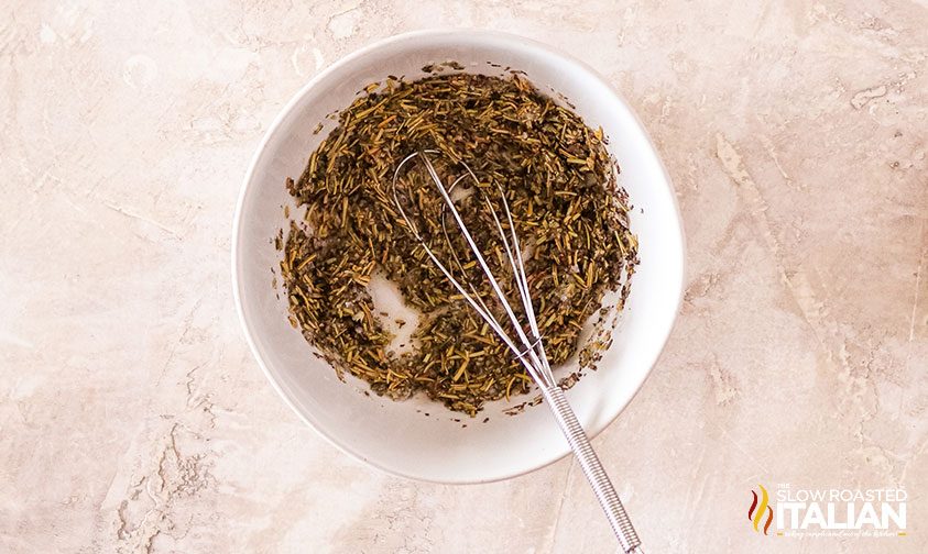 overhead: herb rub for pork in white bowl