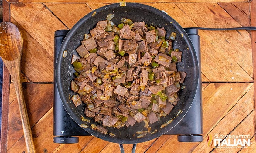 peppers, onions and roast beef in skillet