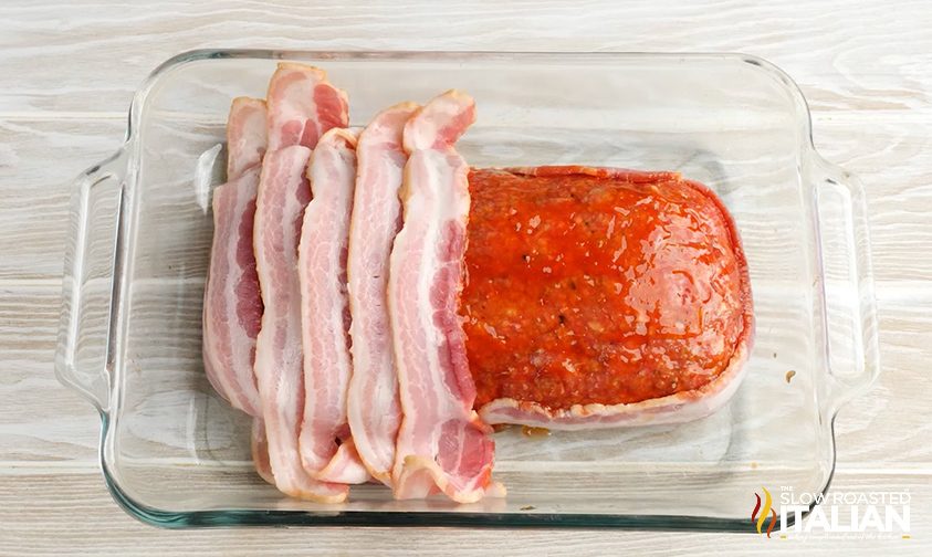 Placing bacon on stuffed meatloaf