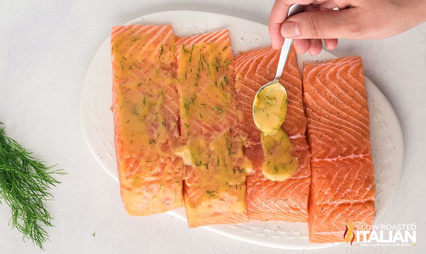 spooning sauce on salmon