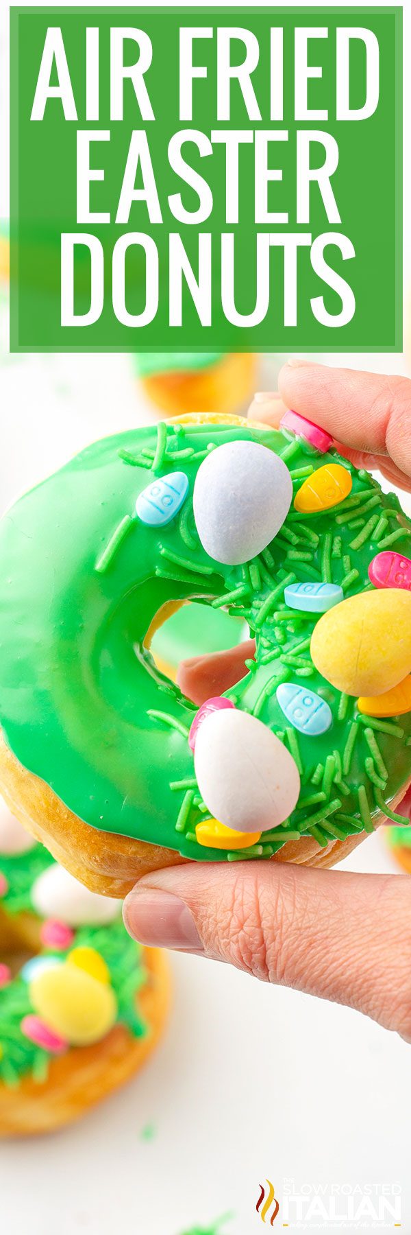 holding easter decorated air fryer biscuit donuts