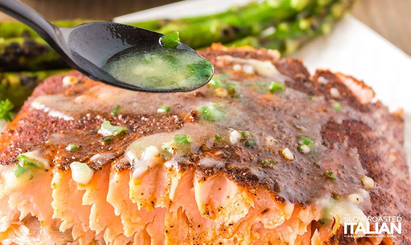 Seasoned butter spooned over smoked salmon