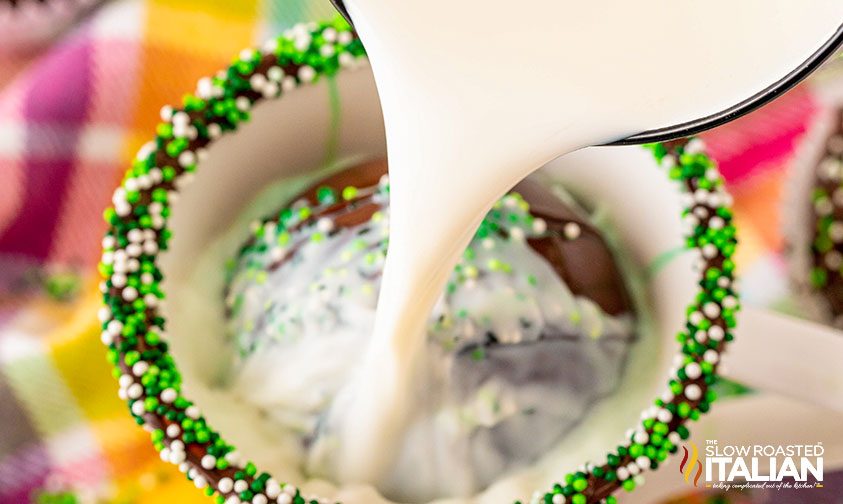 pouring milk over hot chocolate bombs