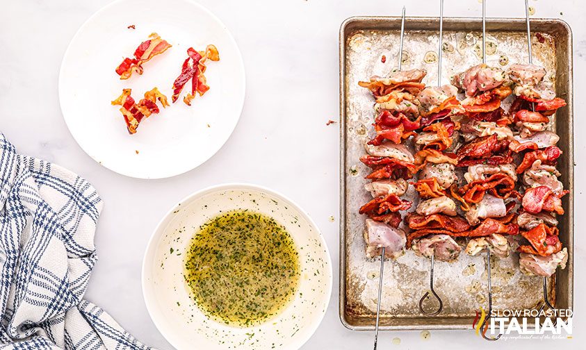 chicken skewers with bacon being prepped