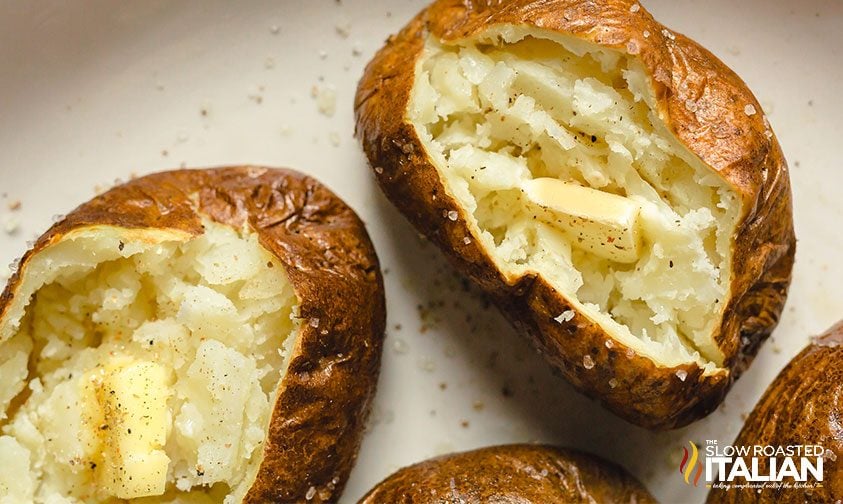 overhead: air fryer baked potato with butter and seasoning