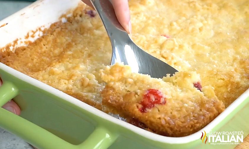 cherry dump cake scooping out a serving