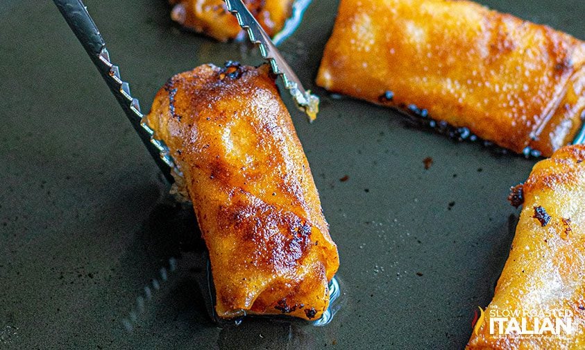 chicken spring rolls being fried