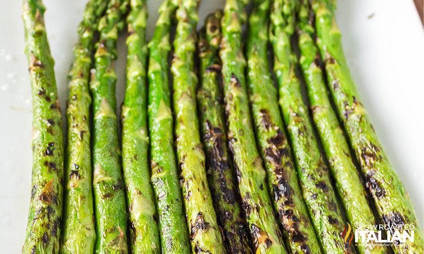 spears of grilled asparagus on white plate