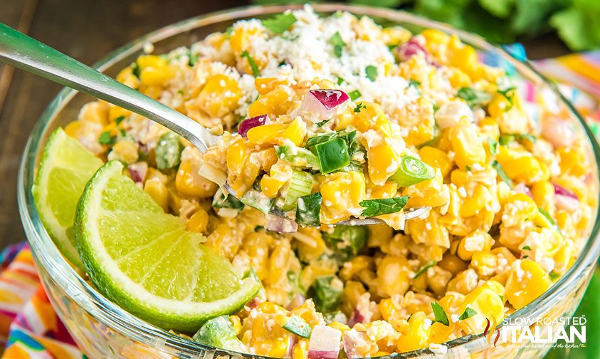 spoon in bowl of elote off the cob