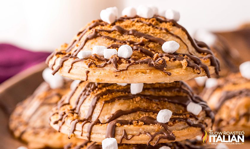 Air Fryer Hand Pies stacked with chocolate drizzled and marshmallows on top