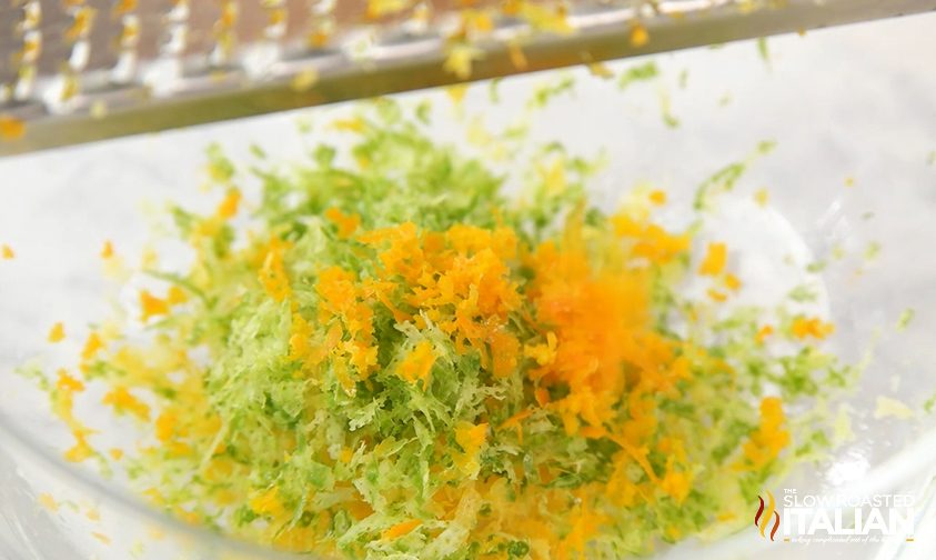 lime zest and lemon zest in glass bowl, close up