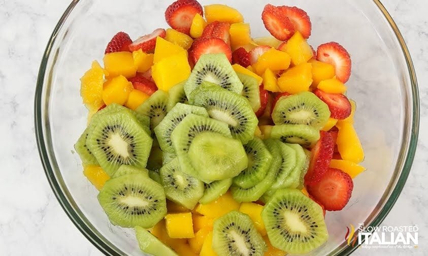 slices of kiwi mango and strawberries in bowl