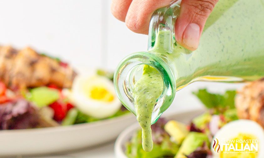 green goddess salad panera pouring on salad