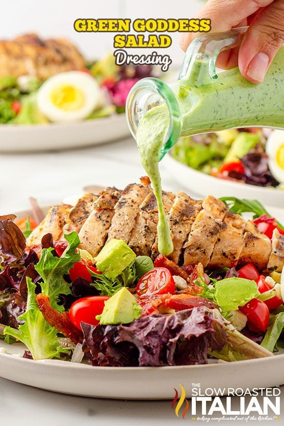 Green goddess salad dressing poured over a salad