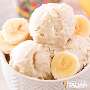 closeup of three scoops of nice cream in a bowl with slices of banana