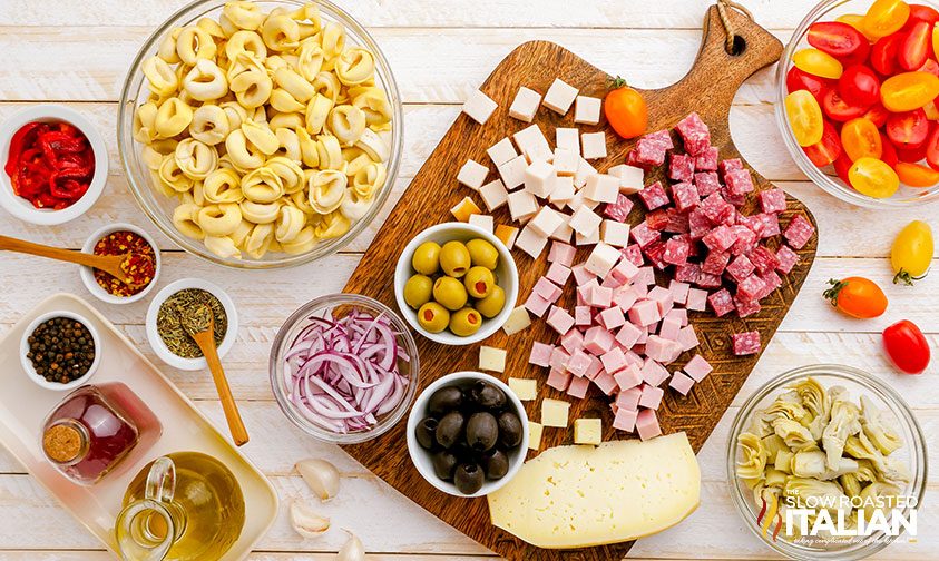 antipasto ingredients on cutting board and counter top