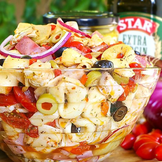 antipasto pasta salad in glass serving bowl