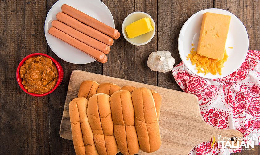 overhead: weiners, buns, shredded cheese and other toppings on counter