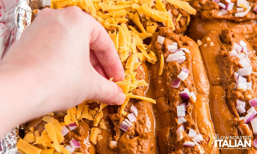 assembling baked chili cheese dogs