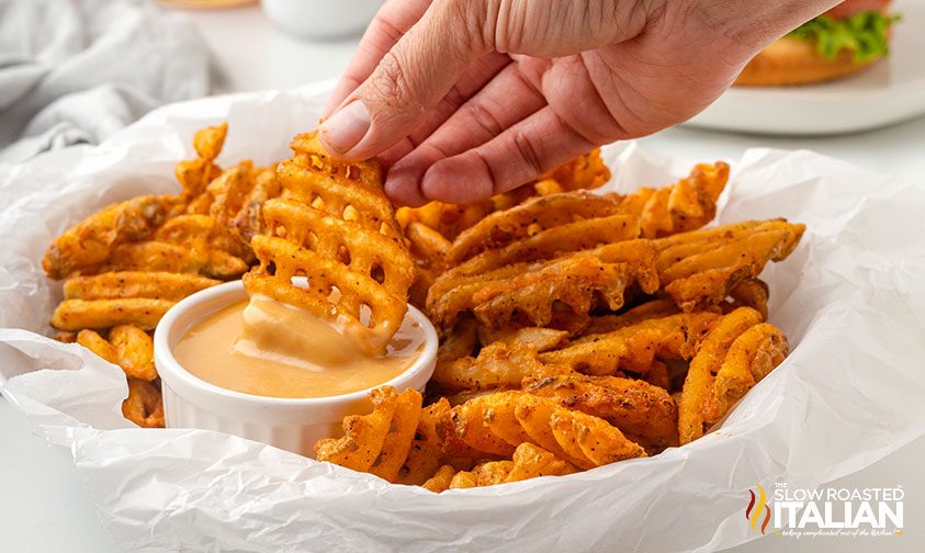 dipping waffle fries into chick fil a sauce