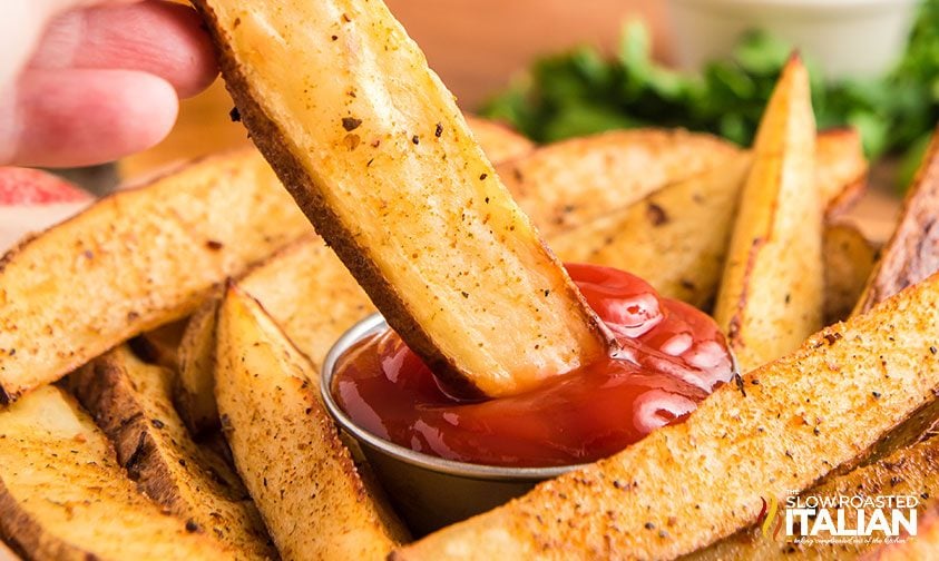 red robin fries dipped in ketchup -close up