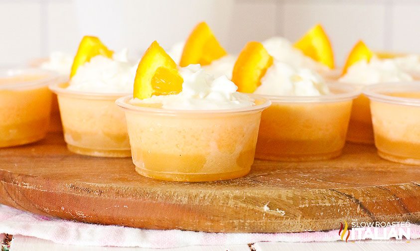 Creamsicle Jello Shot cups on wood board