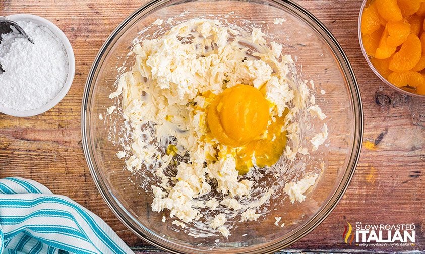 combining cream cheese and orange juice concentrate in bowl