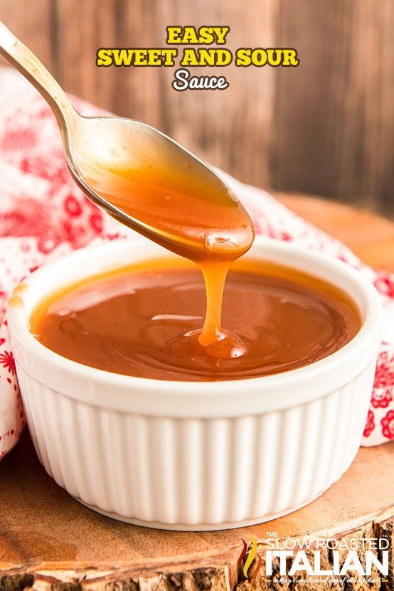 sweet and sour sauce in a white bowl - spoon above the bowl