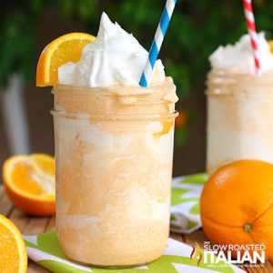 orange creamsicle shake in mason jar glass with whipped cream and straw