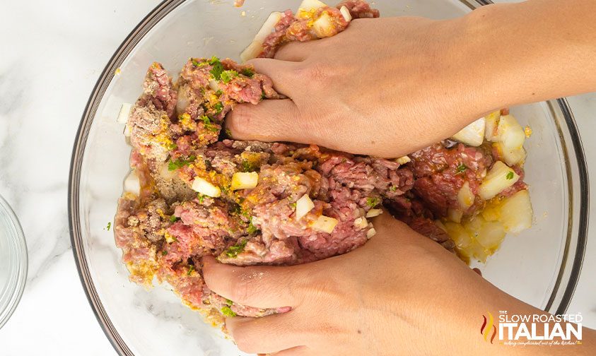 mixing easy meatloaf recipe with hands