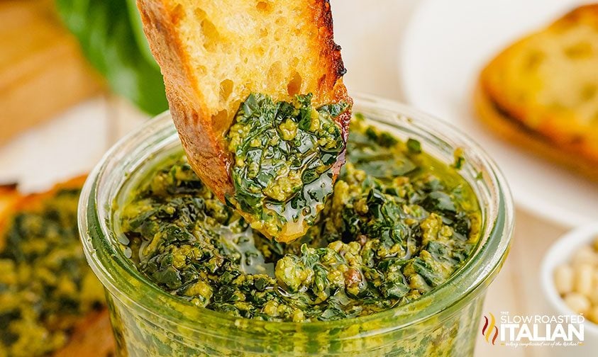 dipping bread into pesto Genovese