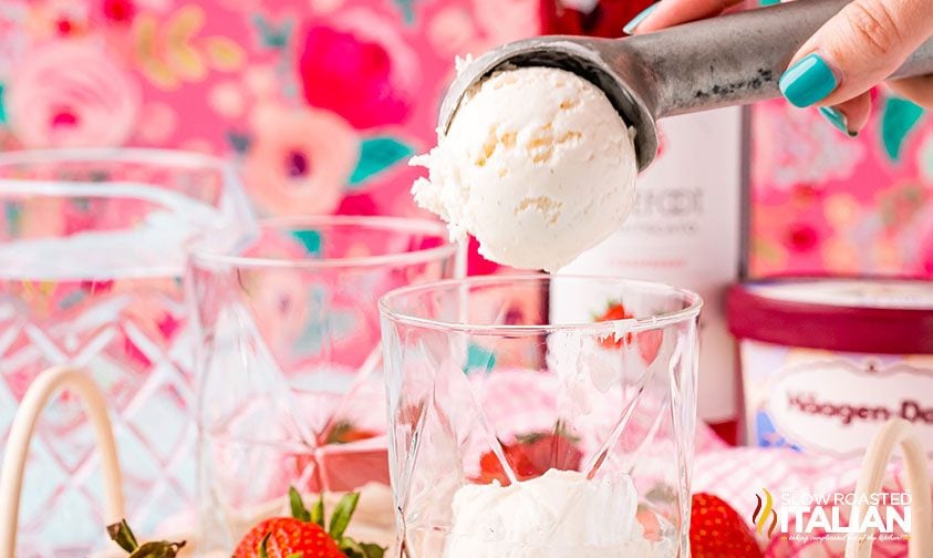 scooping vanilla ice cream into a glass