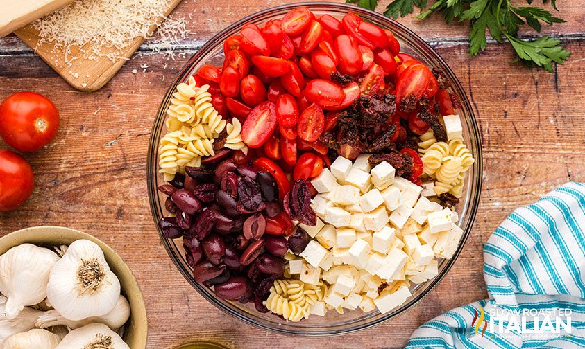 feta pasta salad ingredients individually sectioned in bowl