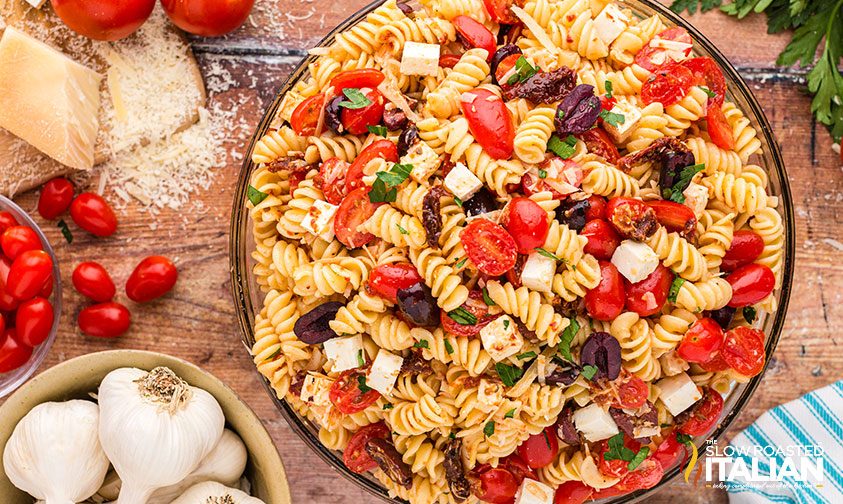 rotini with olives tomatoes and cubes of cheese in large bowl
