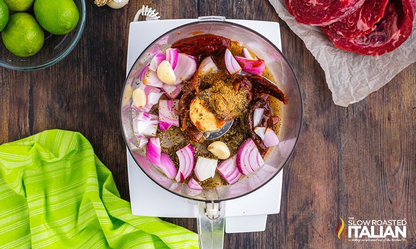 onion and garlic with spices in food processor bowl
