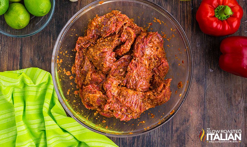pieces of beef marinating in a bowl