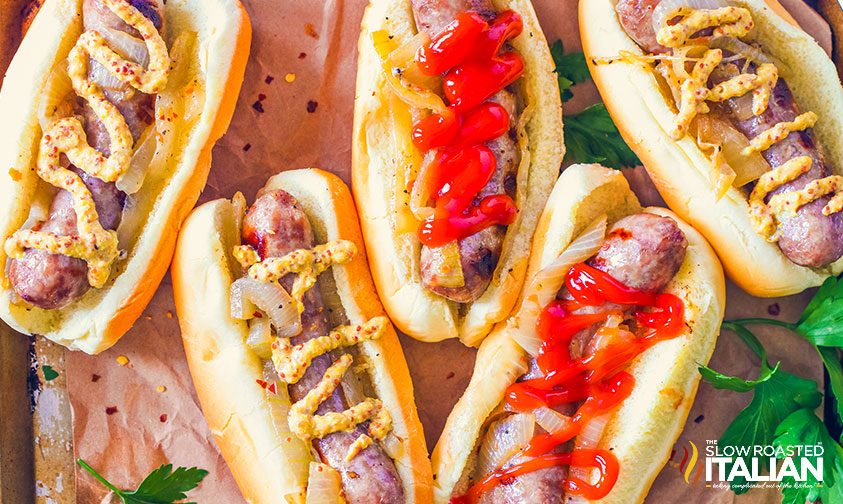 crockpot beer brats on buns with onions and condiments
