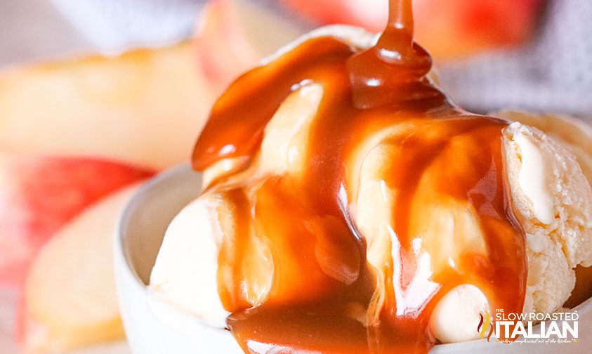 pouring thick caramel sauce over vanilla ice cream