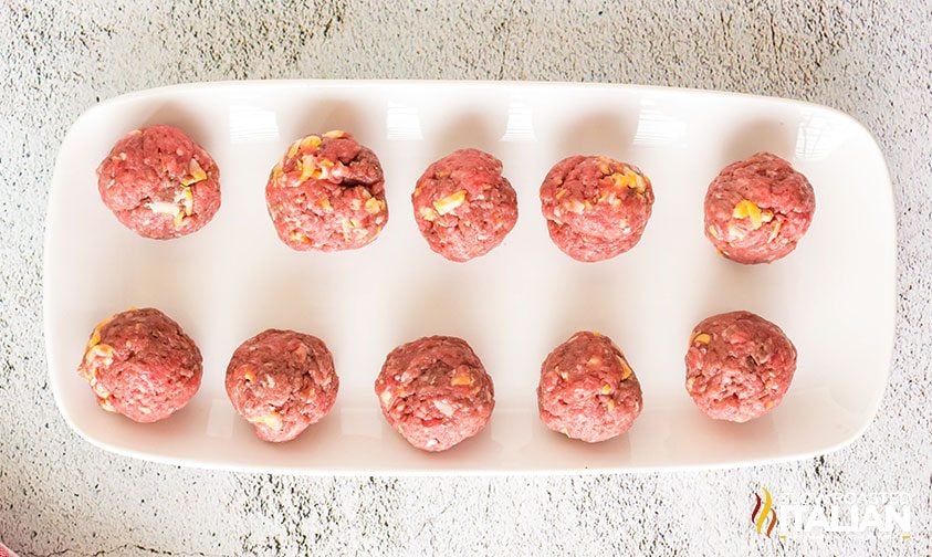 uncooked beef meatballs on tray