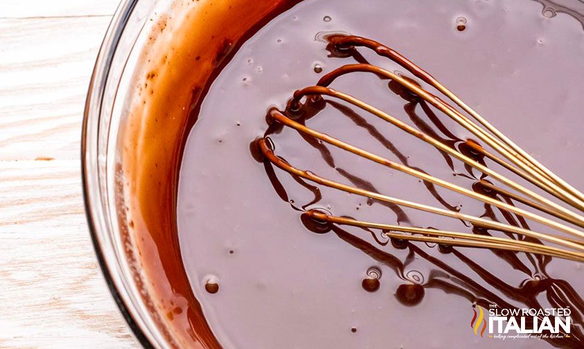 whisking chocolate sauce in pan