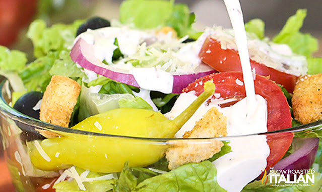 closeup olive garden salad dressing on salad