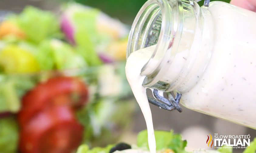 pouring olive garden italian dressing from a jar