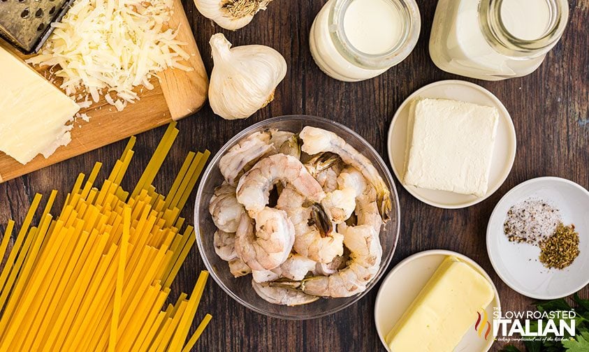 shrimp alfredo ingredients in bowls on counter