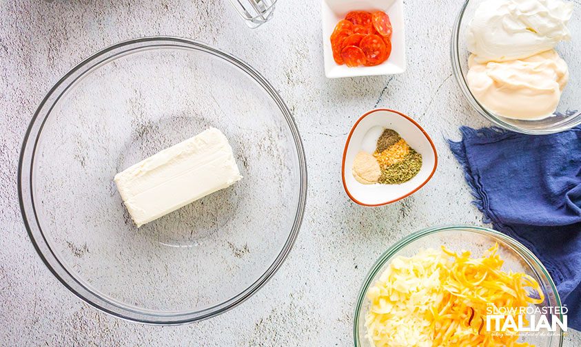 pepperoni pizza dip ingredients in bowls on counter