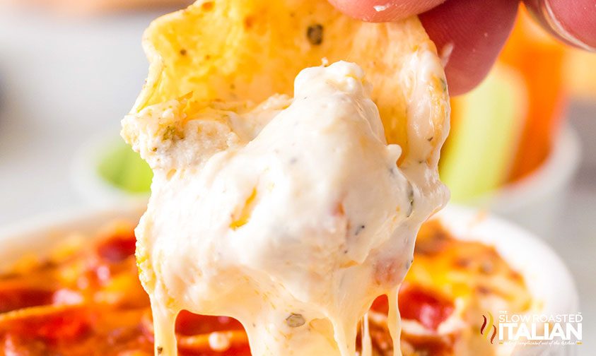 pizza dip on tortilla chip, close up