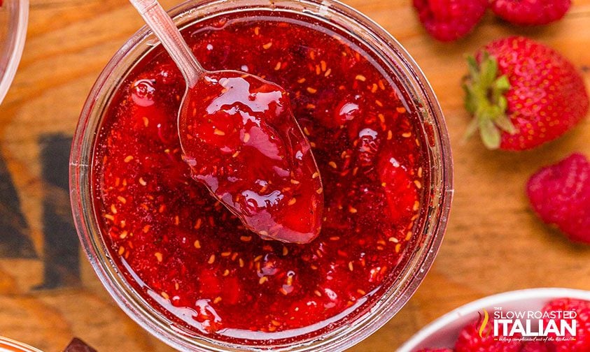 mixed berry jam on a spoon in a jar