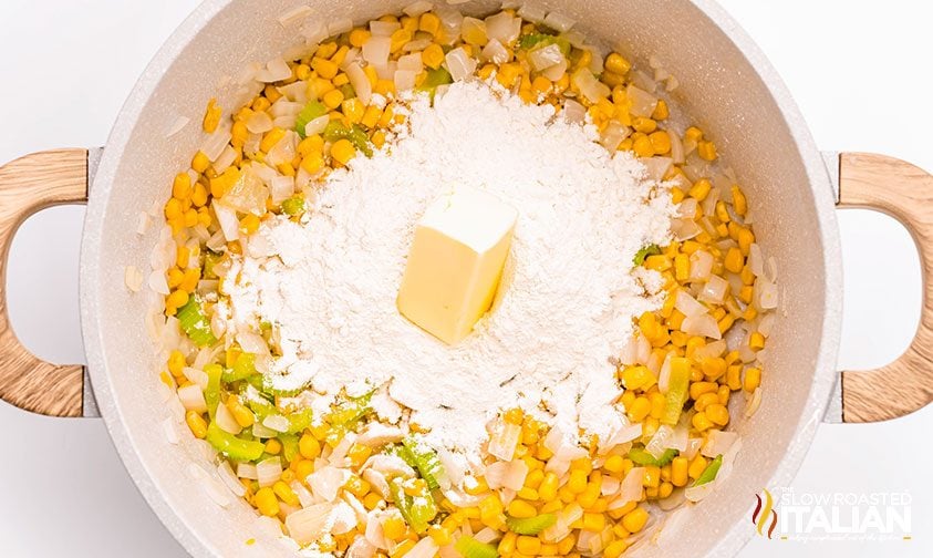 adding flour and butter to pot with diced vegetables