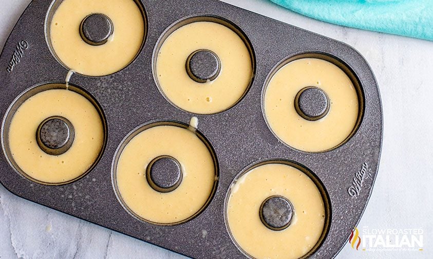 unbaked cinnamon sugar donuts in a donut pan